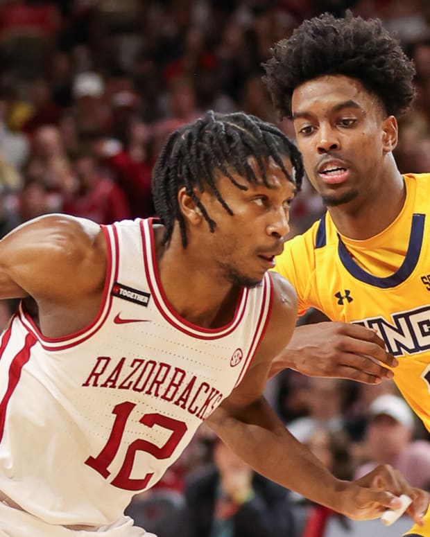 Razorbacks' Tramon Mark drives against UNC-Greensboro's Donovan Atwell